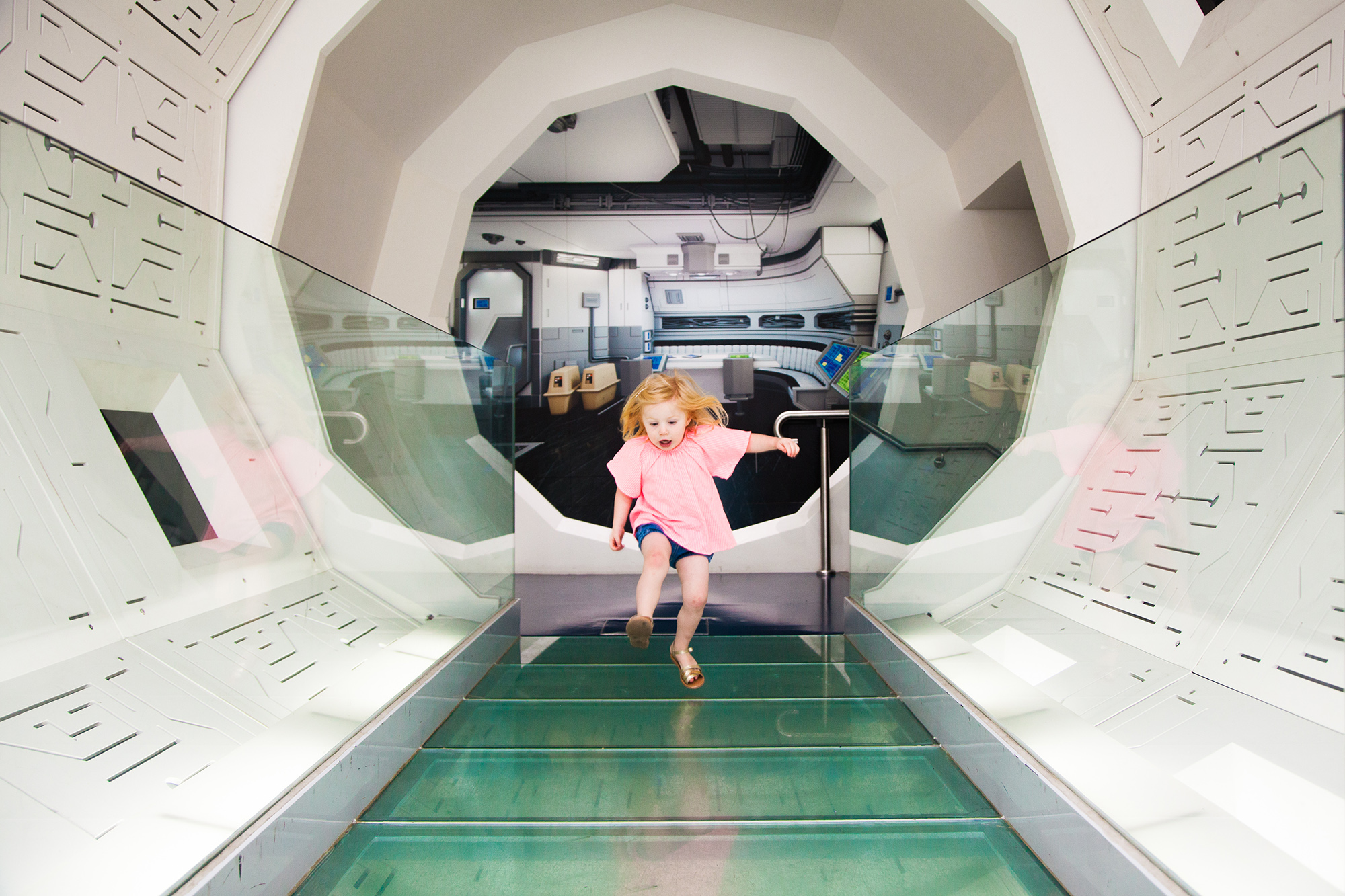Girl running through a white tunnel
