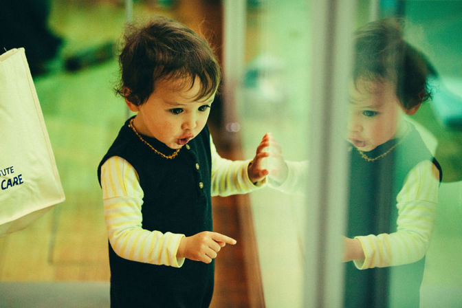 Child pointing at a museum display.