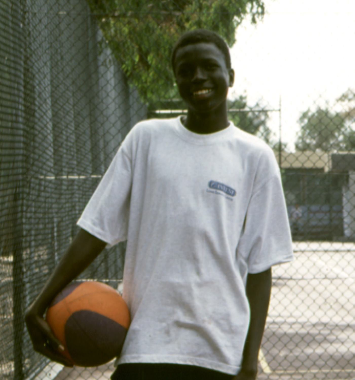 Sudanese teenager holding a basketball