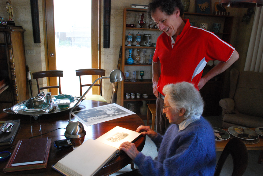 Will Twycross and his mother Mary, 2008, looking at an album of photographs surrounded by objects purchased by Will's great grandfather, John Twycross, at Melbourne's International Exhibitions.