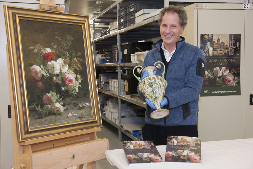 Will Twycross in Store E, Level 2, Melbourne Museum, with the publication 'Visions of Colonial Grandure' and objects from the Twycross Collection.