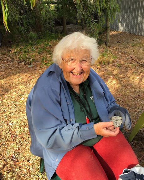 Woman holding a small fossil