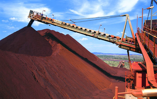 Stacking iron ore onto a large stockpile