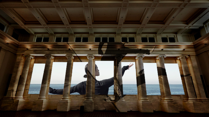 Moving images of Amrita Hepi and her collaborators projected onto the walls of the Immigration Museum's Long Room