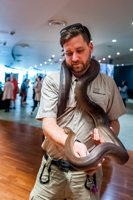 A python rest around a man's shoulders