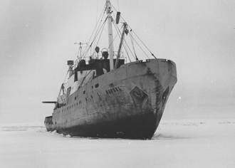 An icebreaker ploughs through a sheet of ice. 
