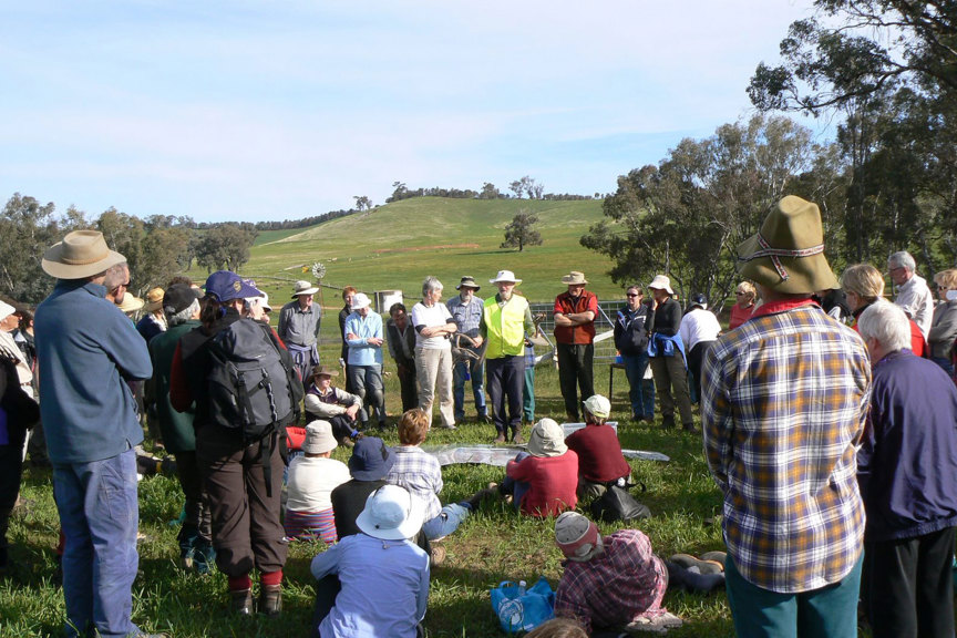 Group of people standing together in a paddock