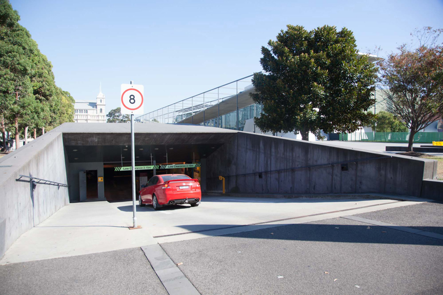 Red car entering Melbourne Museum's car park