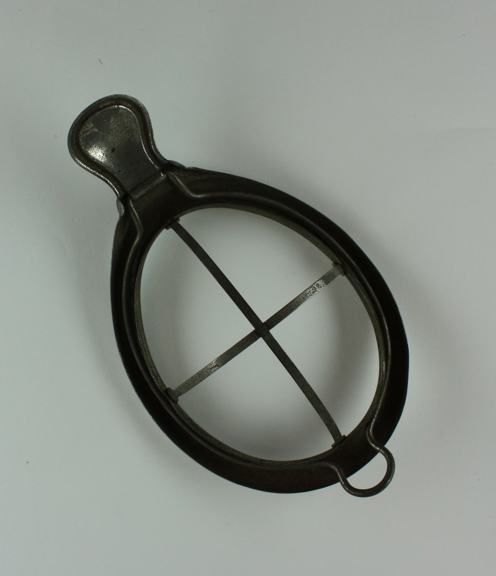 Anaesthetic mask frame comprising gutter around face (to prevent leakage of the anaesthetic) and frame with hinged section, which clips open to allow the placement of a cloth to be soaked in the anaesthetic).