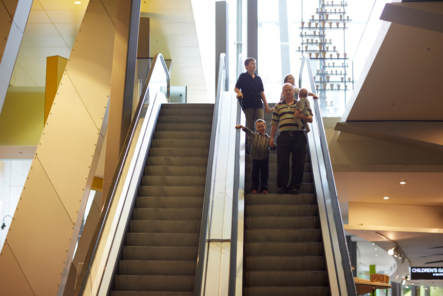 A family on an escalator at Melbourne Museum