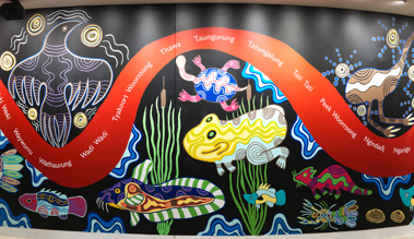 Section from the wall of the Birrarung Gallery featuring a 28 metre mural in honour of Victoria's 44 language groups