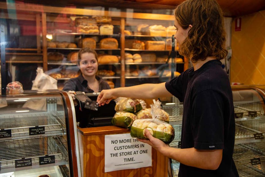 Shopper buying bread at a bakery