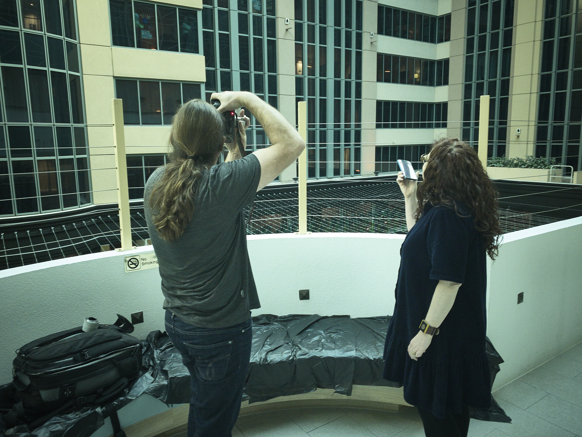 Museum staff photographing people at a hotel