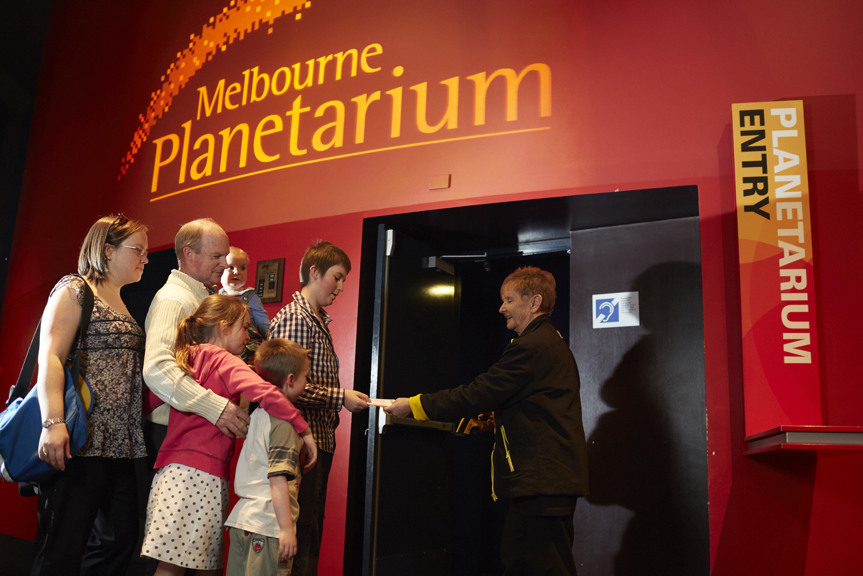 Family lining up for the Melbourne Planetarium getting tickets scanned
