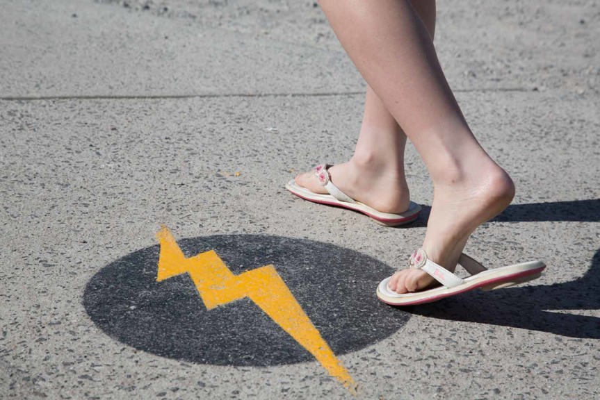 Lightning bolt on ground woman walking