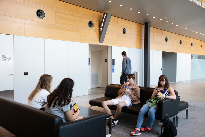 Teenagers having a break from the Road To Zero educational program, sitting in Melbourne Museum lower ground lounge area