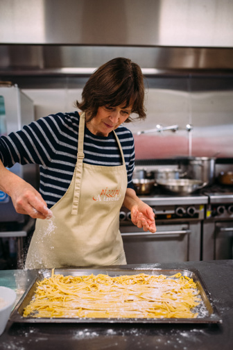 A women makes pasta. 