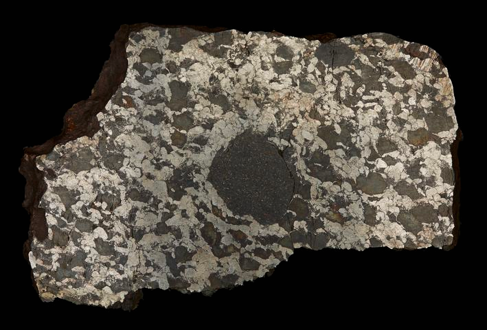 A metallic rock with black blobs trapped inside. 