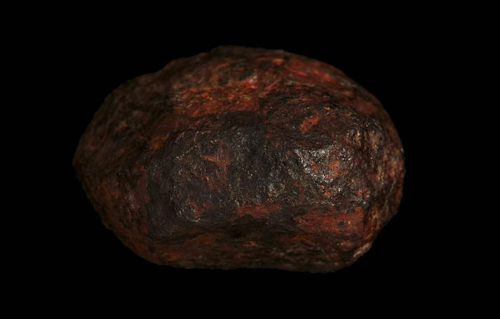 A reddish round rock.