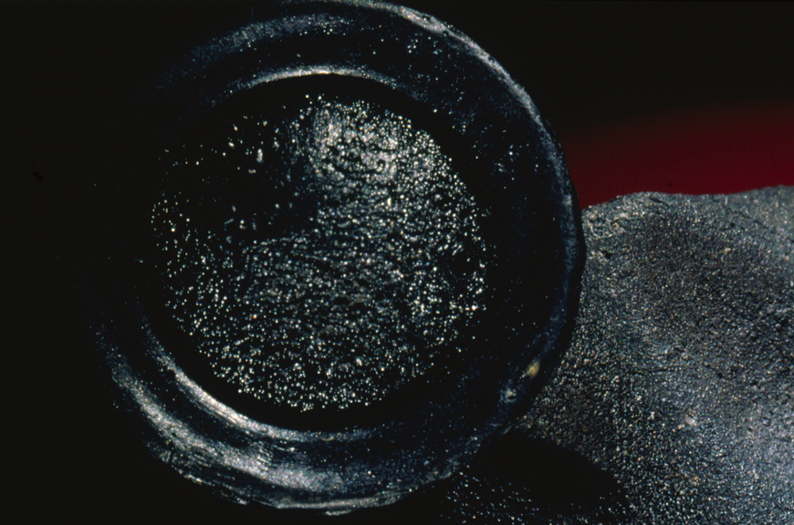 A wierdly shaped black, glassy rock. 