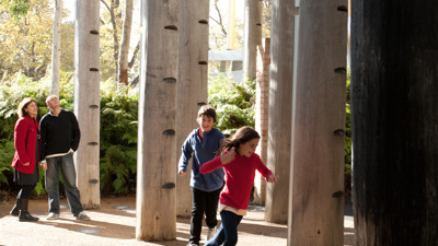 Boy and girl running between trees