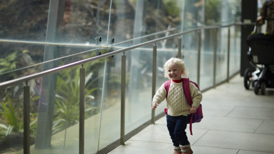 Little girl running past Forest Gallery. 
