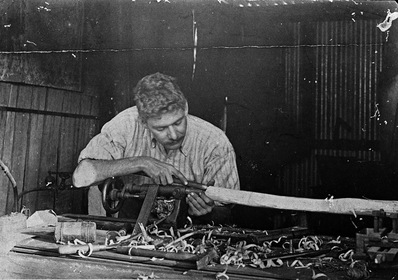 A man using a wood lathe.