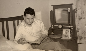 Bruno Ceresoli reading a letter from an unknown correspondent in his bedroom at 230 Palmerston Street, Carlton, a boarding house where he rented accommodation, in 1953