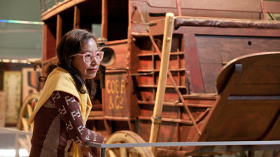 Lady looking at Cobb & Co. coach 