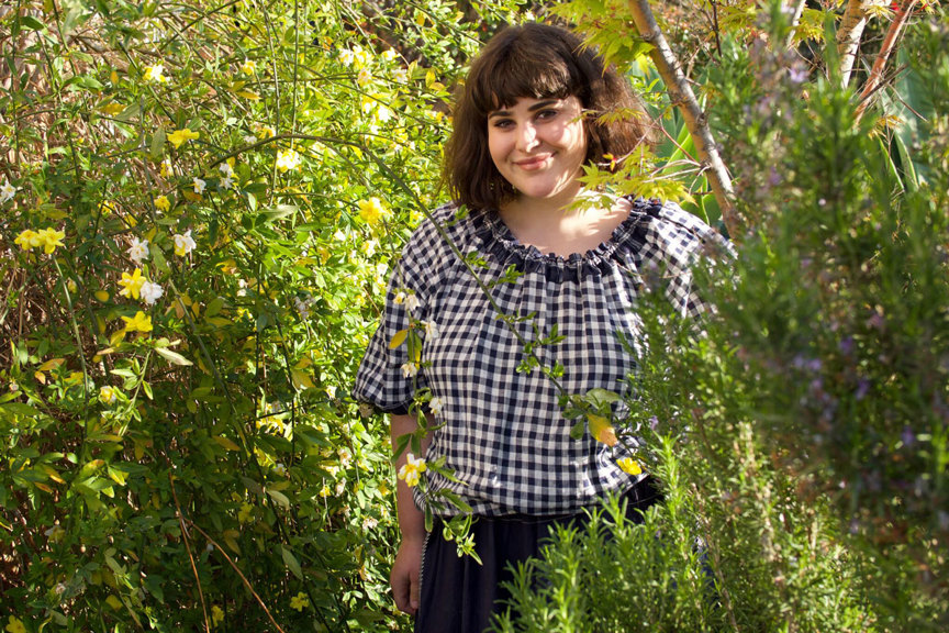 Julia Busuttil Nishimura in her garden surrounded by leaves