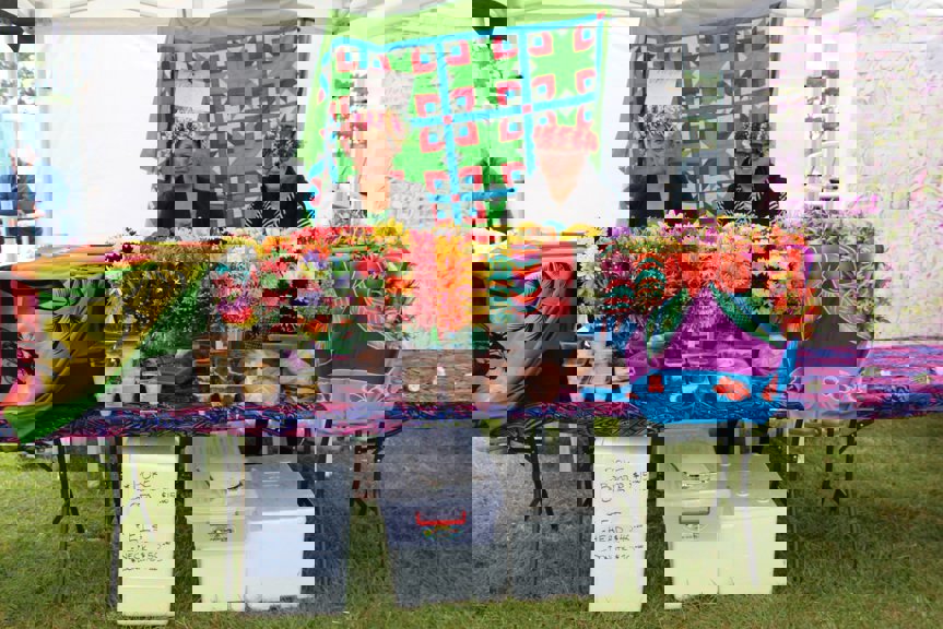 Two women standing behind a table