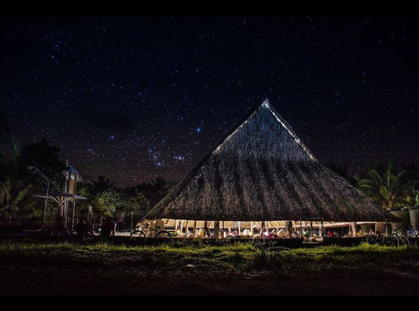 High thatched roof structure without walls at night time