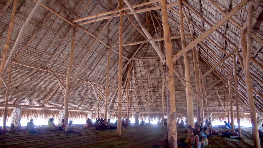 People sitting in groups under the maneaba