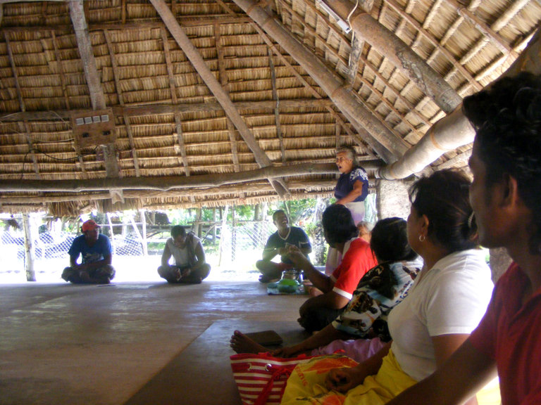 People listening to a women speak in the maneaba