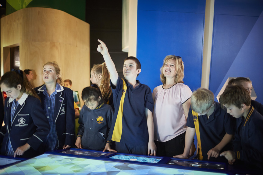 Children with their teacher in the Think Ahead Exhibition