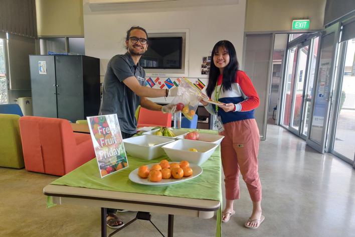 Man and woman sharing fruit