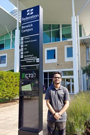 Man next to university sign