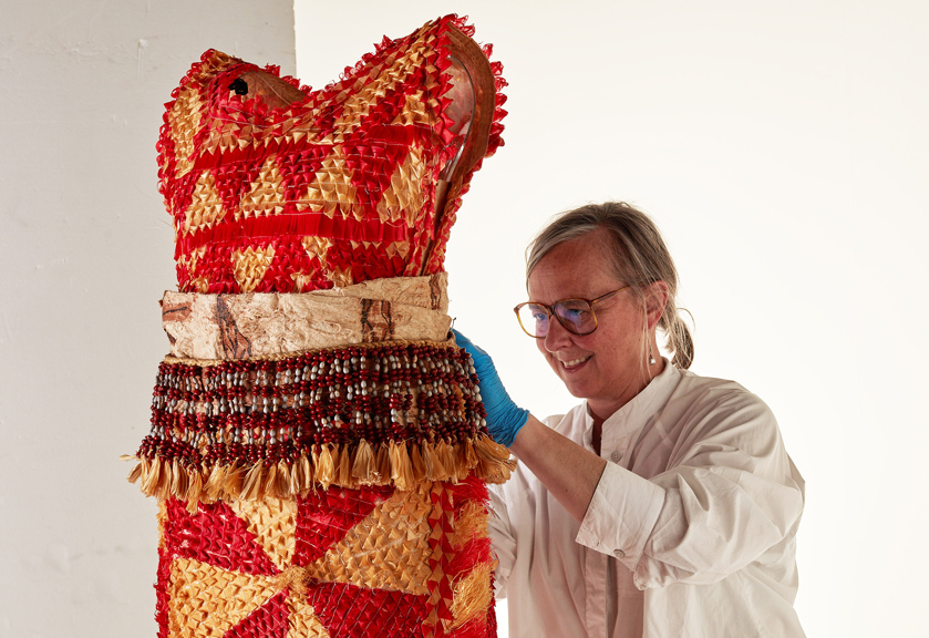 A woman works on a traditional pacific dancing costume