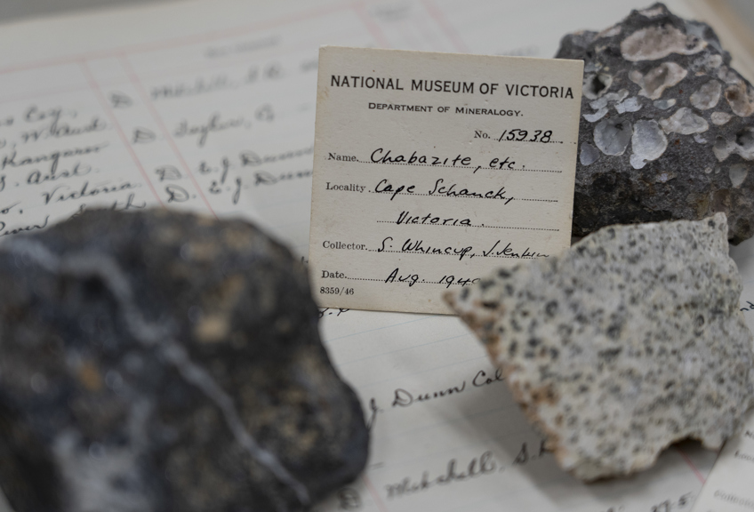 a closeup shot of three rocks with a specimen label