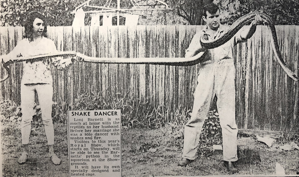 a newspaper clipping of a woman and a man holding a large snake