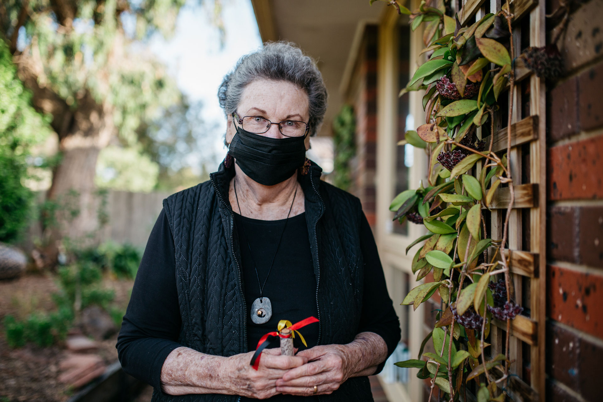Woman holding a small vial
