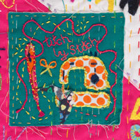 Detail of embroidered quilt showing a sewing machince