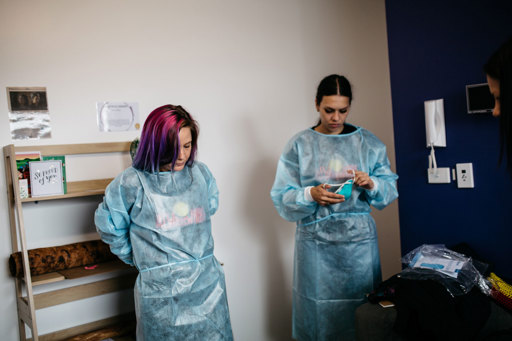 Two woman wearing PPE garments