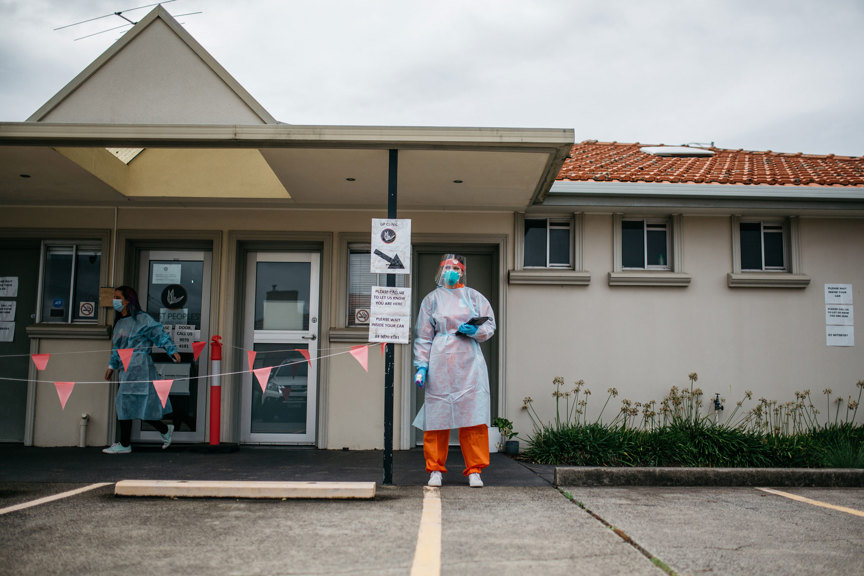 Woman wear PPE garmets standing in a carpark