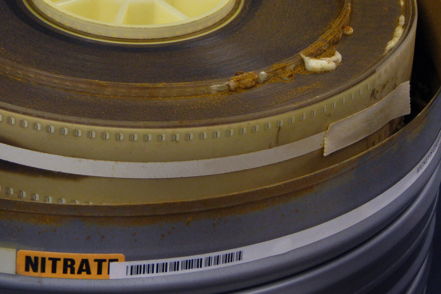 A reel of nitrate film bubbling and turning to dust
