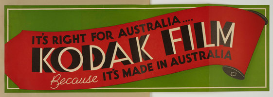 Poster with a green background and red illustration of a roll of film with the text "It's right for Australia..Kodak Film because it's made in Australia"