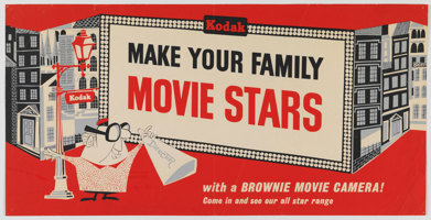 Colour poster, with a strong red theme as well as black, cream and blue tones. It features a cartoon illustration of a male director standing on an urban streetscape, with a Kodak lamp-post behind him.