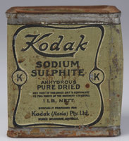 A rectangular tin paint a olive green with a black printed label on the front