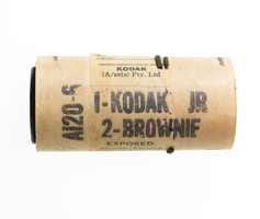 Brown cardboard cylinder with black text printed on it