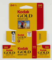 Bundle of 10 un-used, flat pack boxes printed in a yellow, red and black colour scheme with a photograph on the front of a two boys making sandcastles on the beach. 